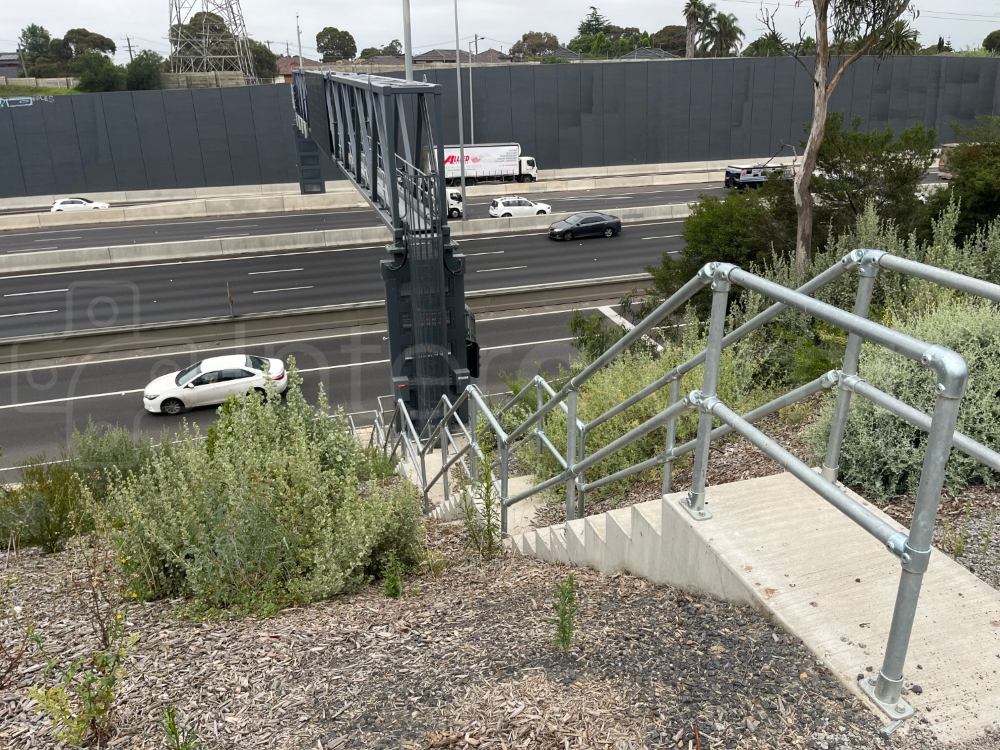 Interclamp steel key clamp handrail installed either side of highway access steps